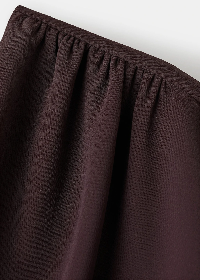 Jumpsuit with asymmetrical neck and bow