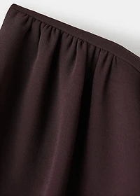 Jumpsuit with asymmetrical neck and bow