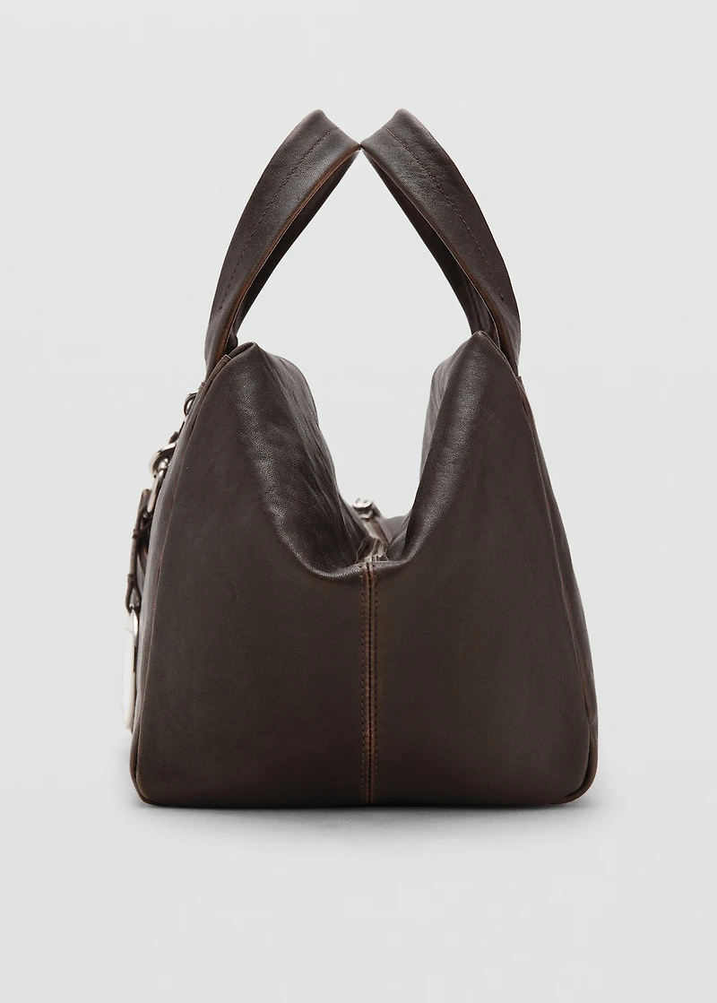 Leather clutch bag with charms