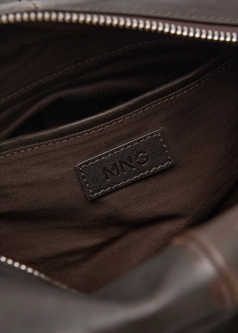 Leather clutch bag with charms