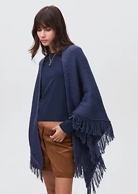 Knitted poncho with tassels
