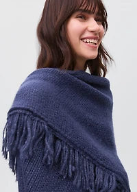 Knitted poncho with tassels