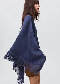 Knitted poncho with tassels
