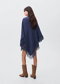 Knitted poncho with tassels