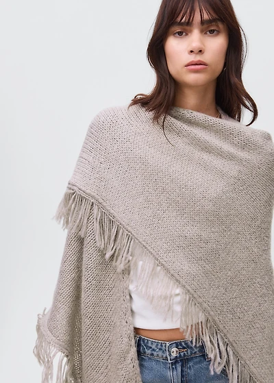 Knitted poncho with tassels