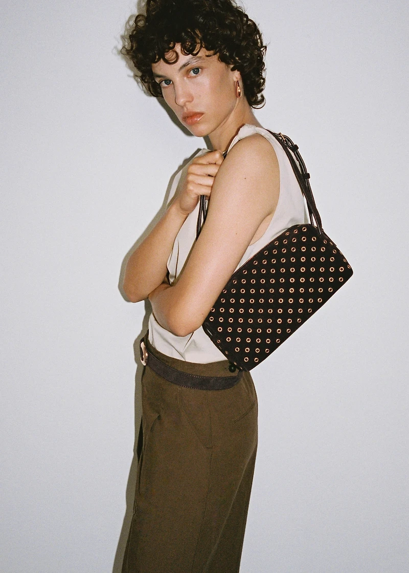 Suede shoulder bag with eyelets