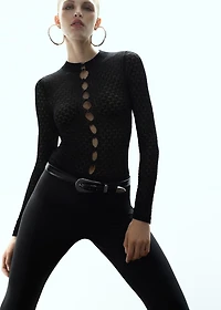 Openwork knitted sweater with bead fastening