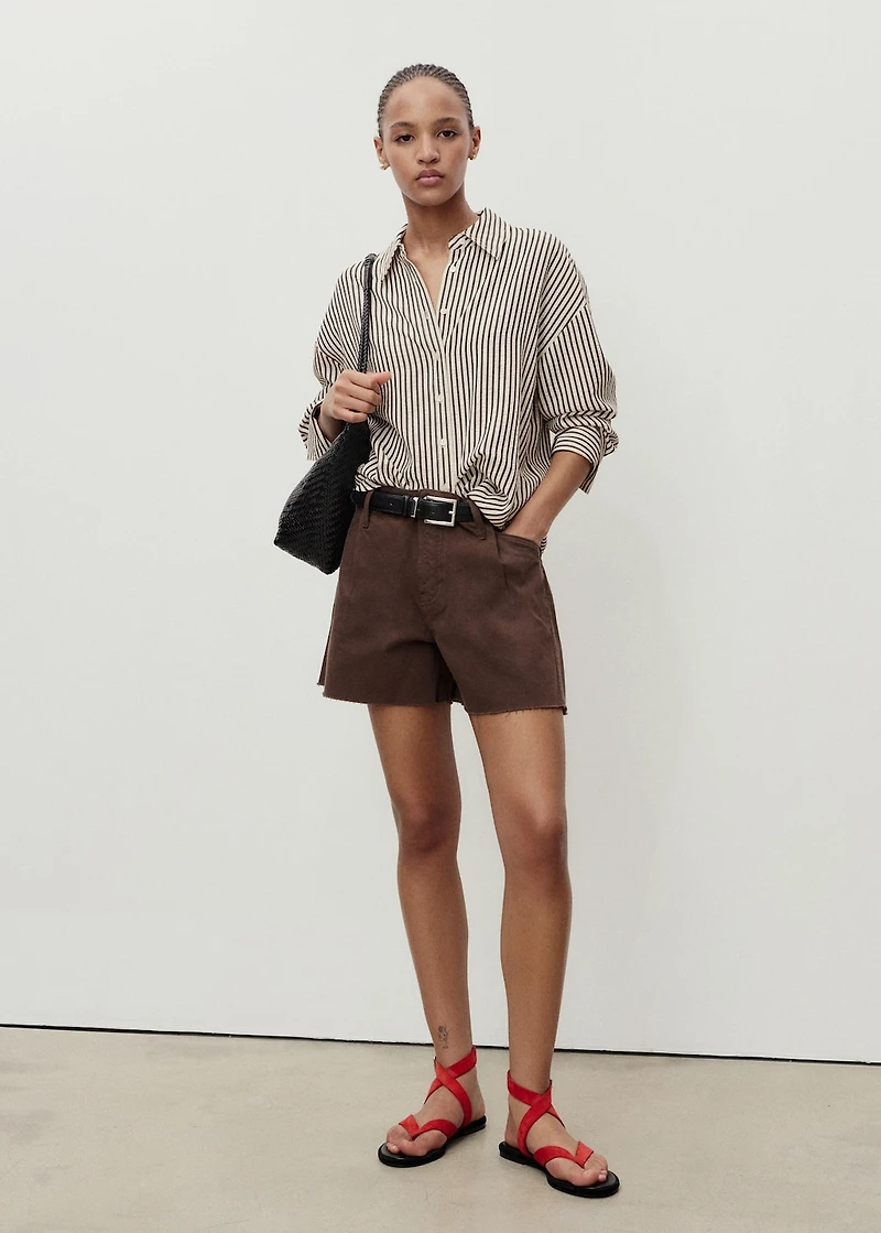 Denim shorts with frayed hem and pleats