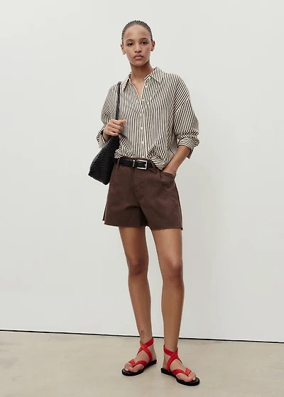 Denim shorts with frayed hem and pleats