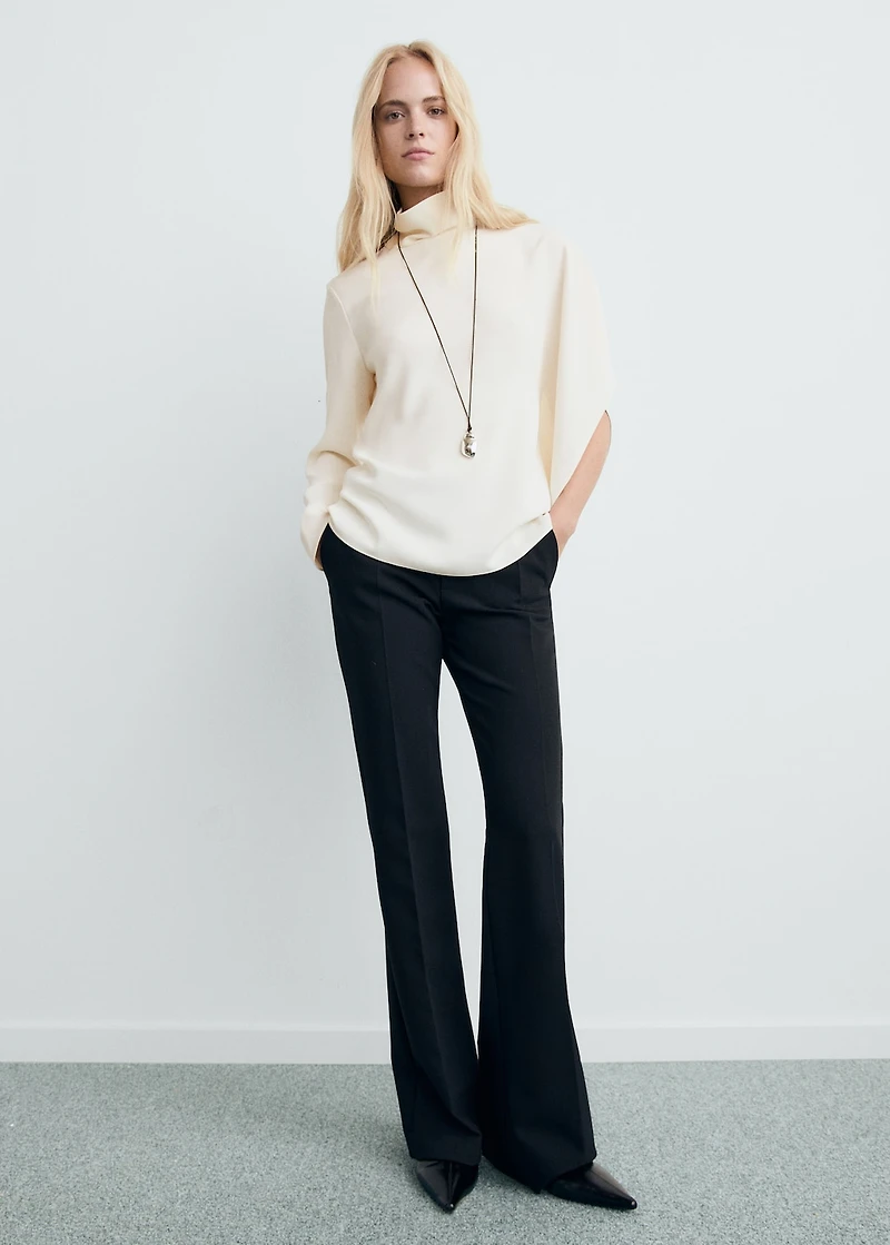 High-neck blouse with asymmetrical sleeves