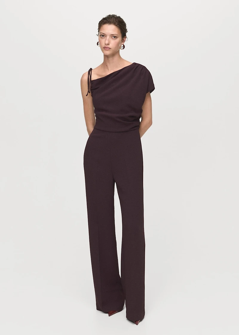 Jumpsuit with asymmetrical neck and bow