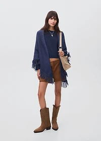 Knitted poncho with tassels