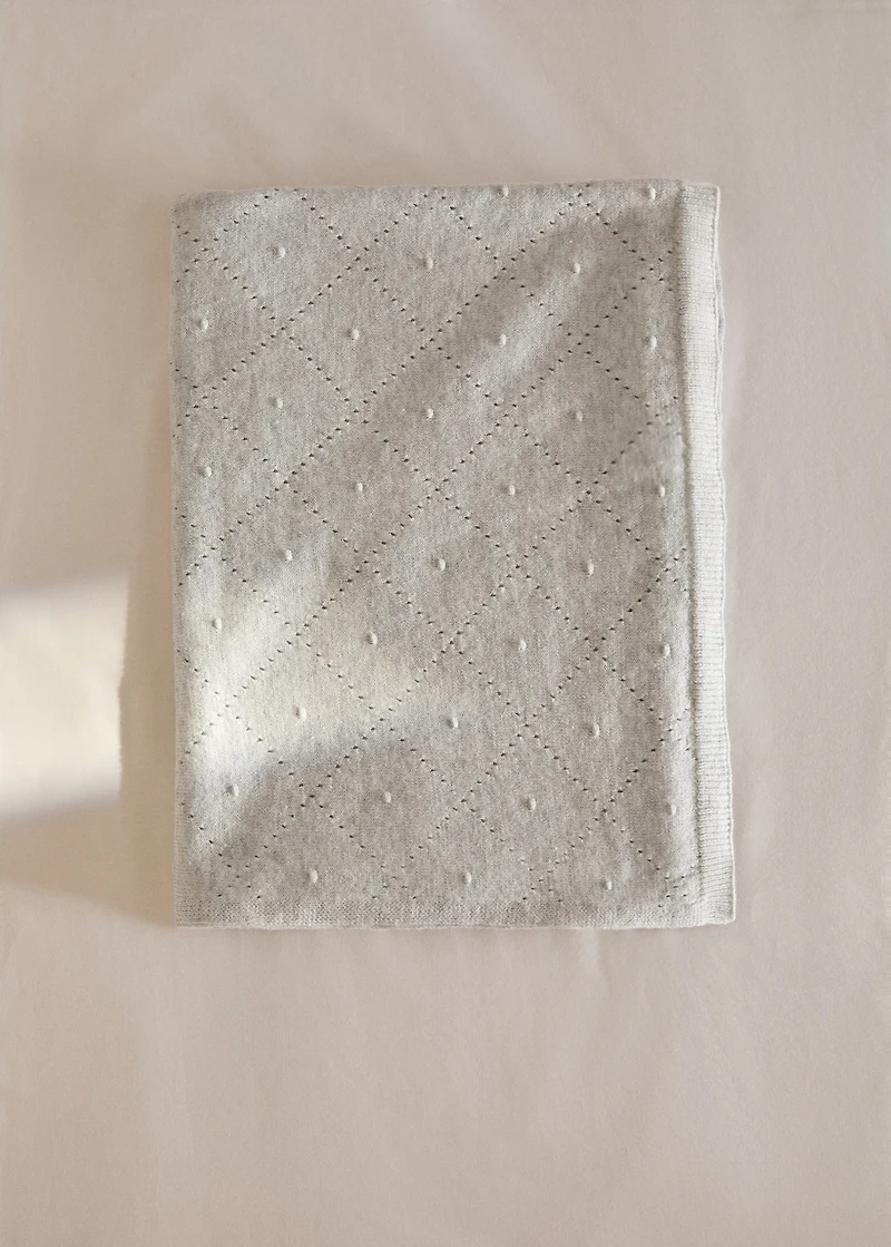 Embroidered children’s blanket with rhombus design