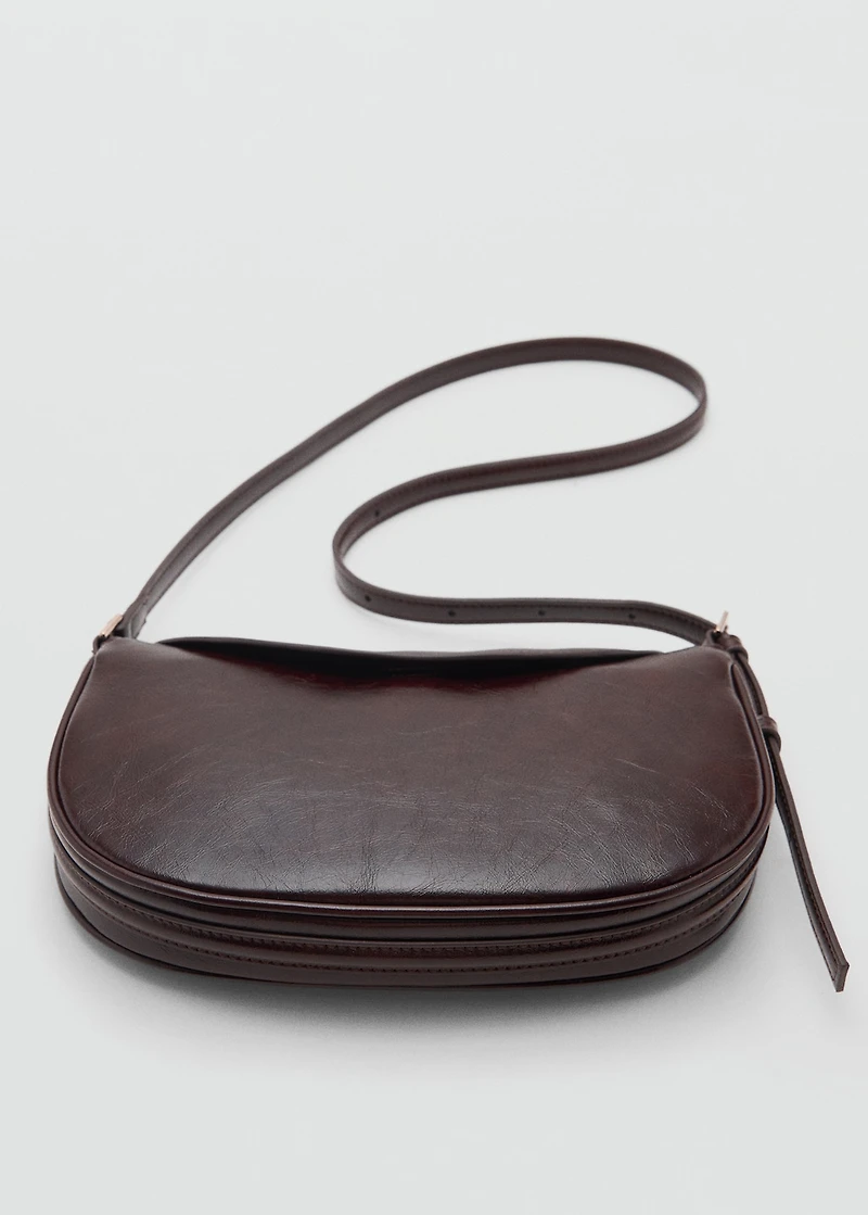 Oval shoulder bag with flap