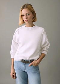 Knitted sweater with seams
