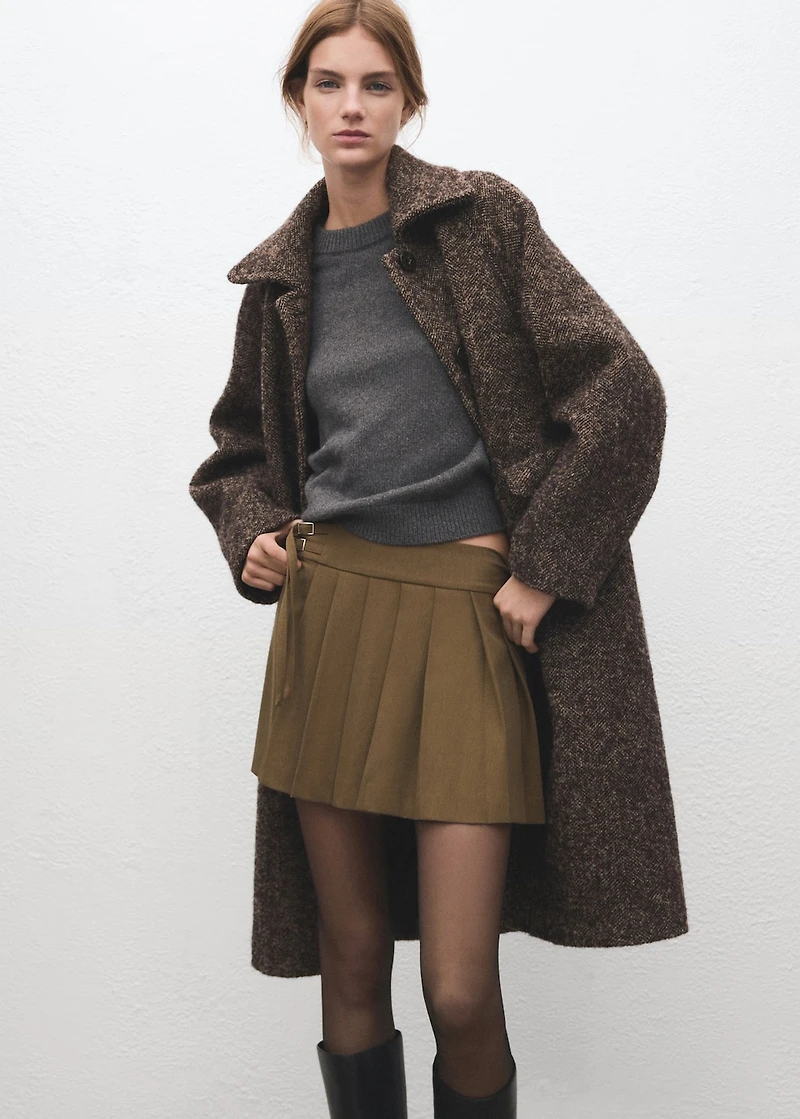 Short pleated skirt with buckles