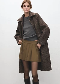 Short pleated skirt with buckles