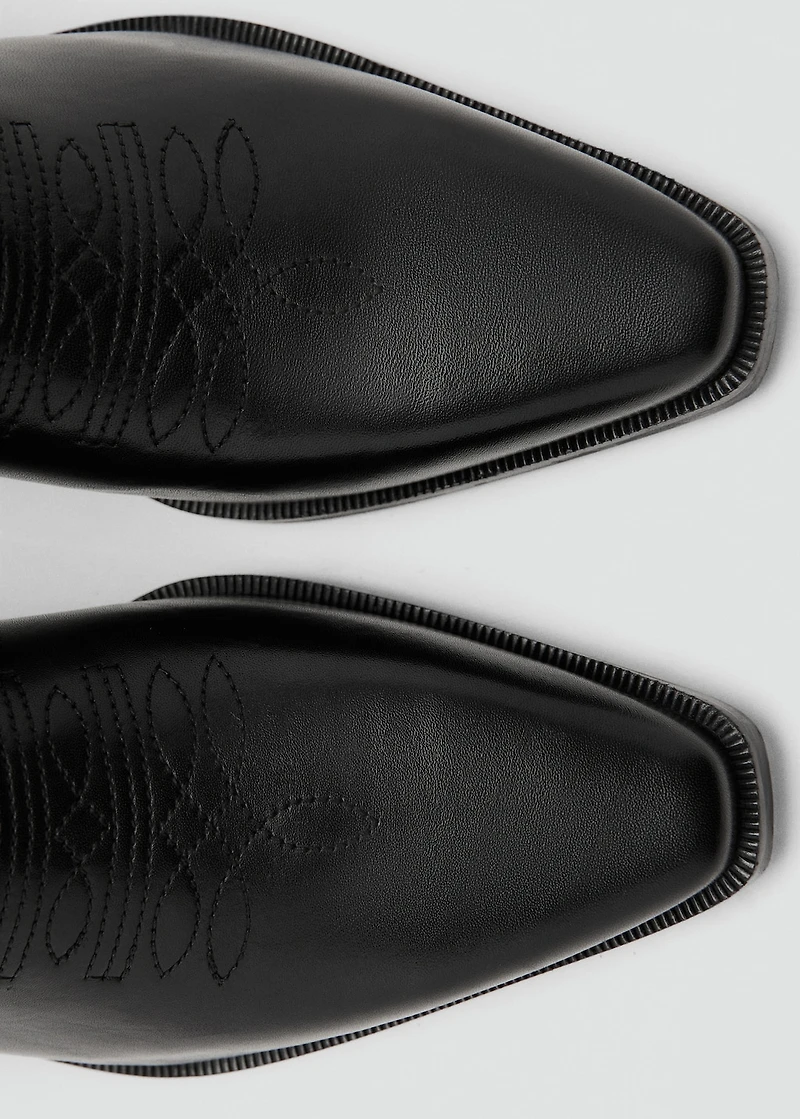 Tall leather boots with tassels