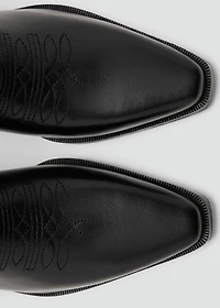 Tall leather boots with tassels