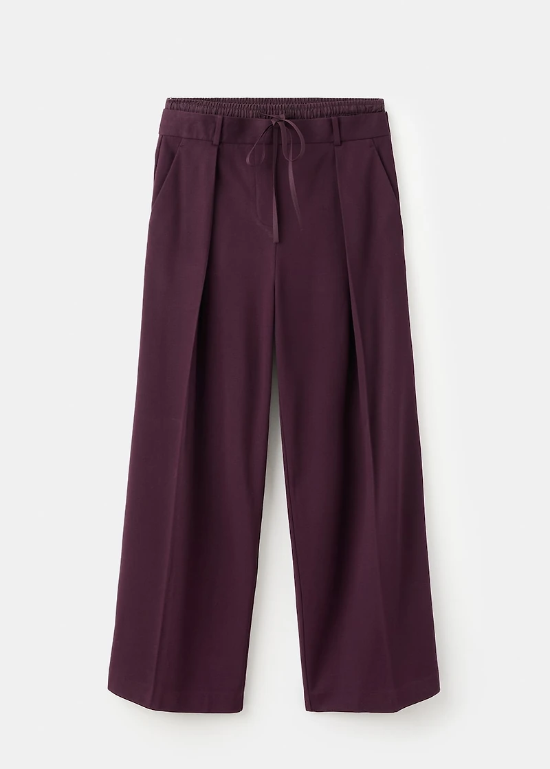Pleated trousers with combined waistband