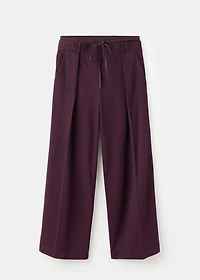 Pleated trousers with combined waistband