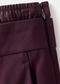 Pleated trousers with combined waistband