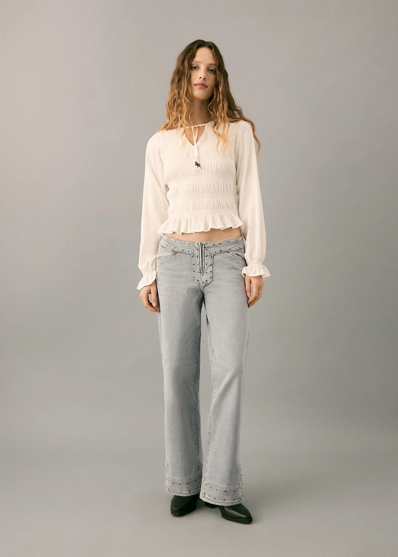 Low-waist studded jeans