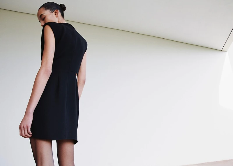 Dress with metal embellishment and cut-out