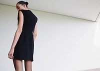 Dress with metal embellishment and cut-out