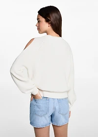 Knitted sweater with openings