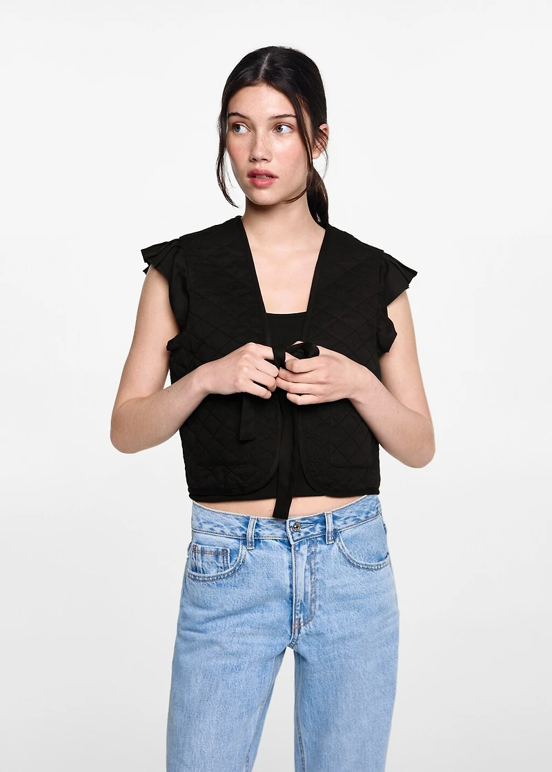 Quilted vest with pleat