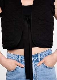 Quilted vest with pleat