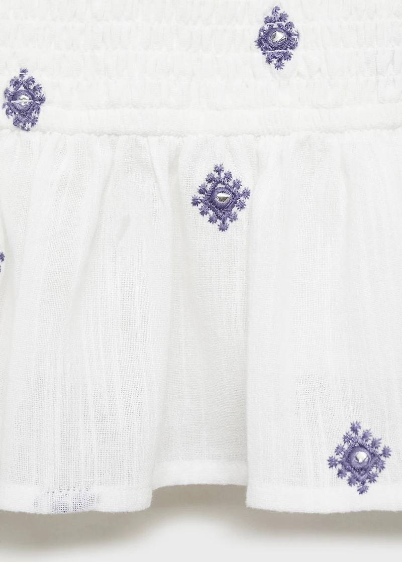 Ruffled blouse with embroidered details