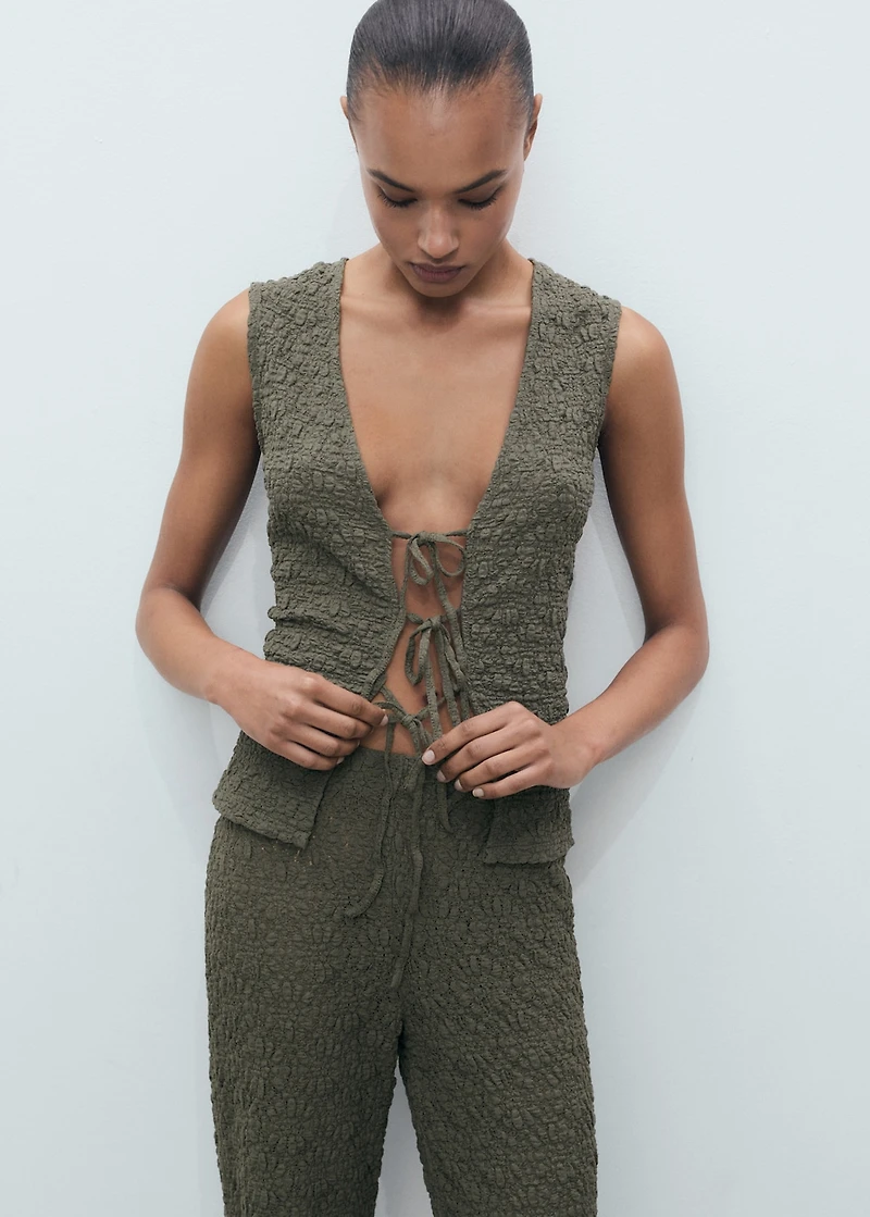 Textured top with bow