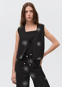 Embroidered top with bow closure