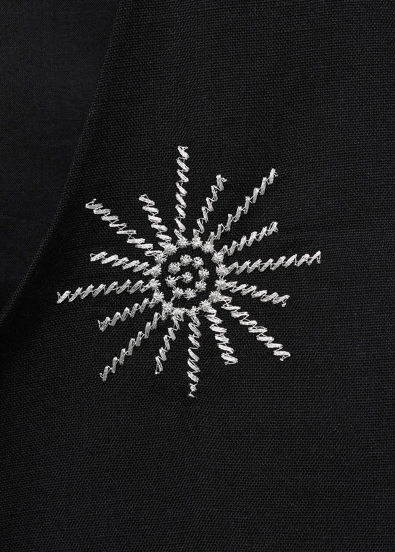 Embroidered top with bow closure