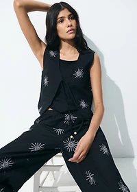 Embroidered top with bow closure