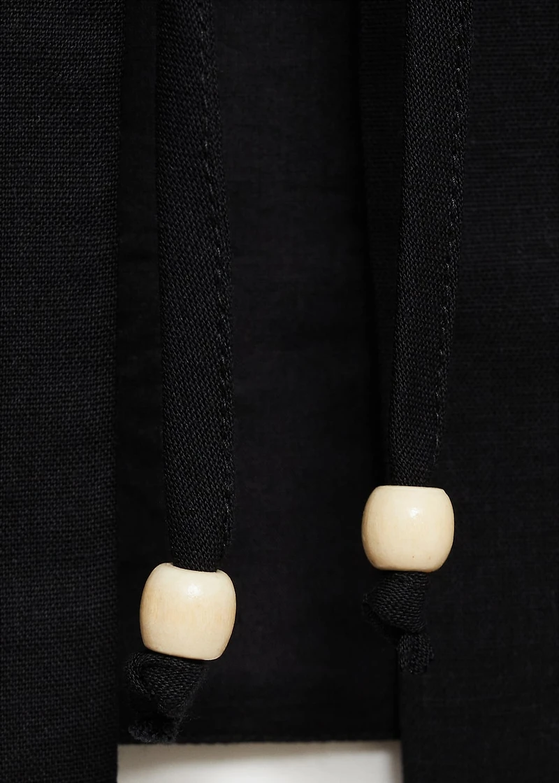 Embroidered top with bow closure