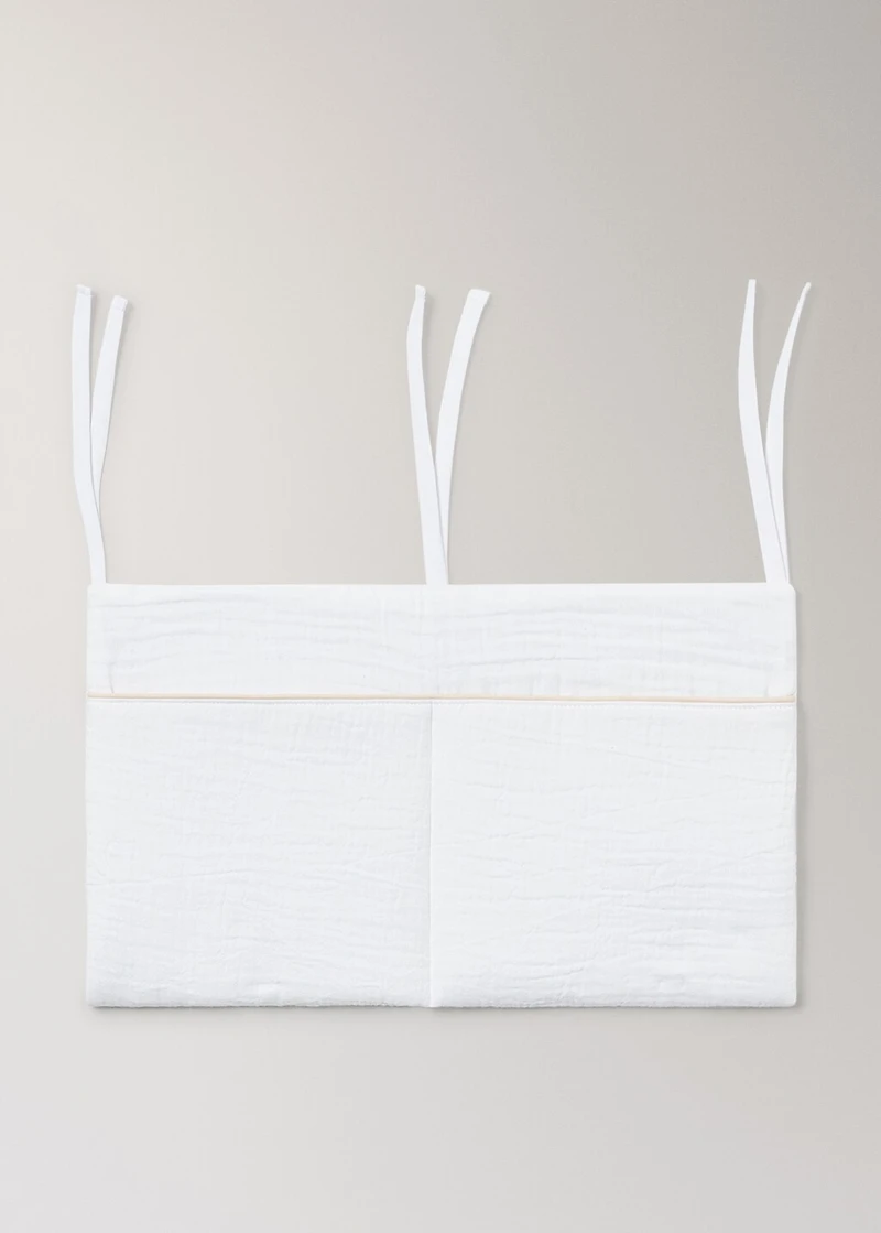 Cot organizer with piping