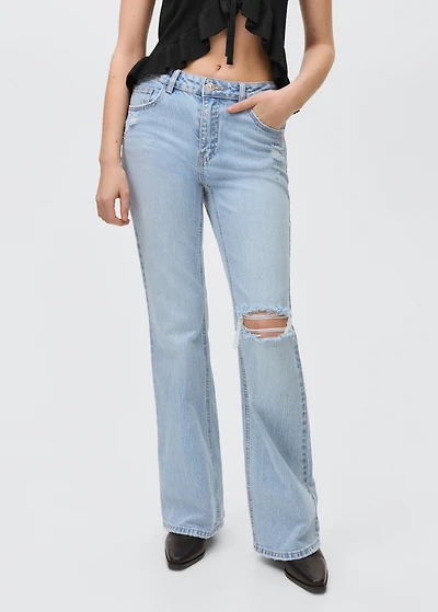 Flared jeans with decorative rips