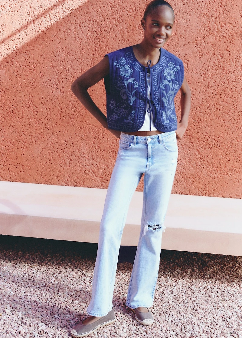 Flared jeans with decorative rips