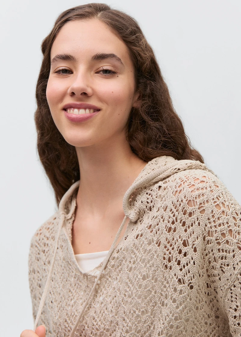 Knitted sweater with hood and lace pattern