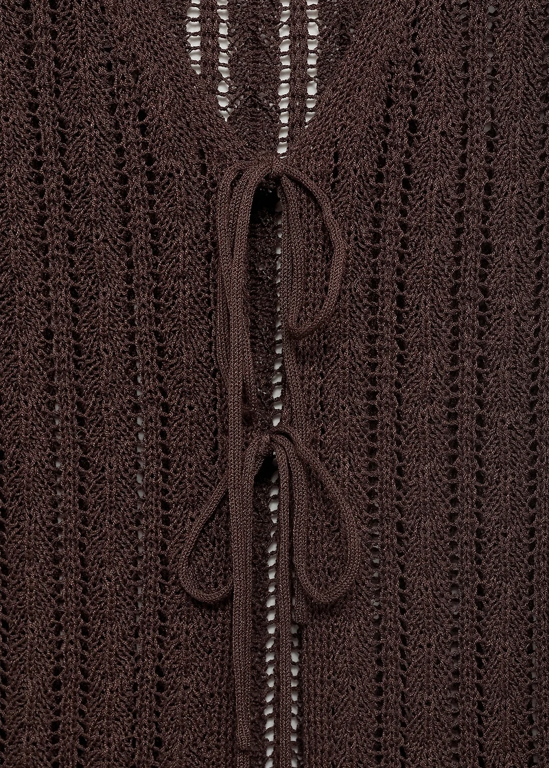 Knitted vest with bow closure