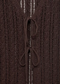 Knitted vest with bow closure