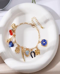 Nicole Miller Gold-Tone Eiffel Tower, Heart, Rose, Horseshoe, Clover, Cherry, and Amor Charms Bracelet