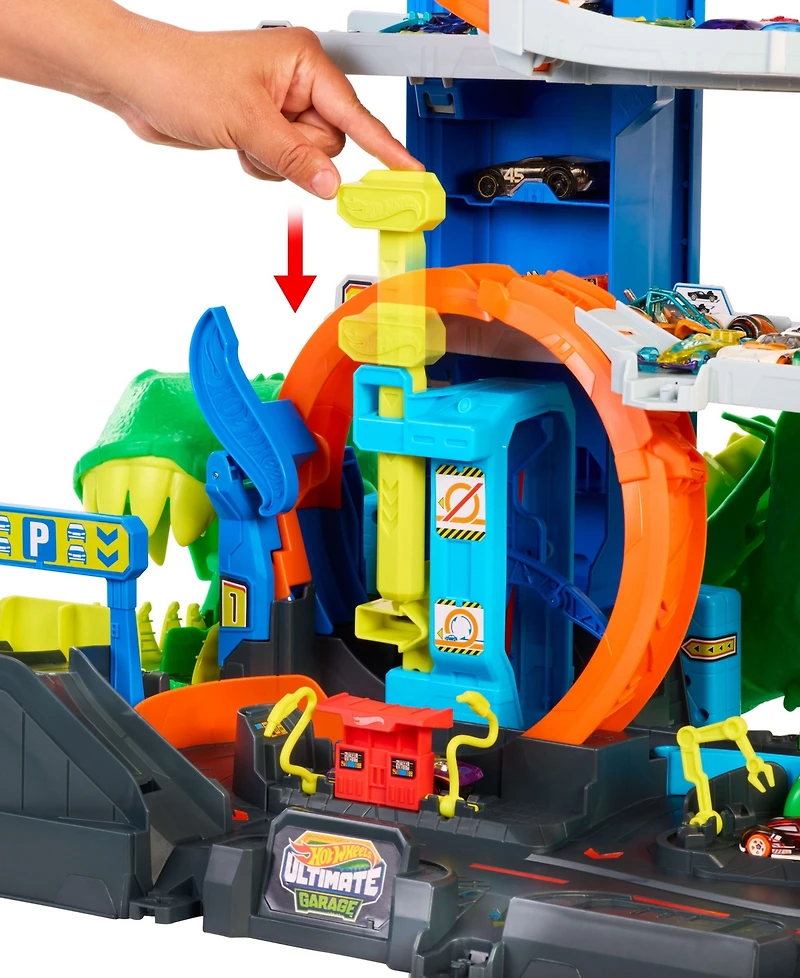 Hot Wheels 1:64 scale City Ultimate T-Rex Garage with 2 Toy Cars & Storage for 50+, Race & Stunt, Dino Nemesis