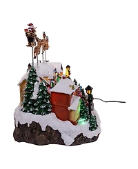 Kurt Adler 7.3-Inch Battery Operated Multicolor Led Lighted Musical Santa and Sleigh Table Piece