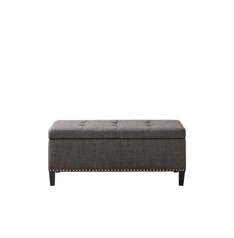 Modern tufted storage bench with soft-close lid, grey linen upholstery, button tufting, black wood legs, and interior for bedroom or entryway.