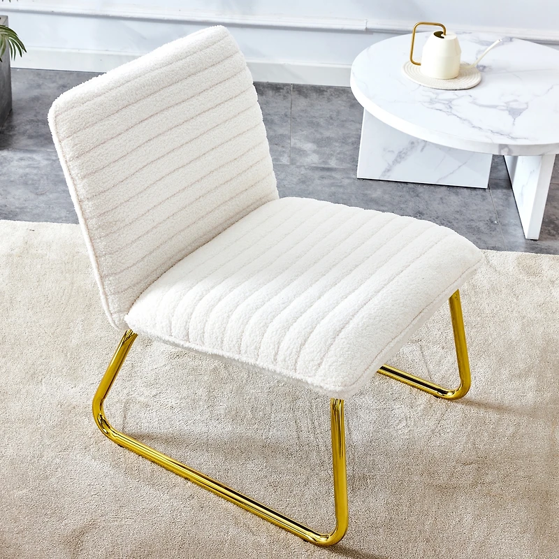 White armless sofa chair with gold legs. Versatile for any space