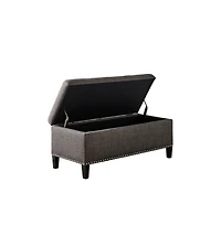 Modern tufted storage bench with soft-close lid, grey linen upholstery, button tufting, black wood legs, and interior for bedroom or entryway.